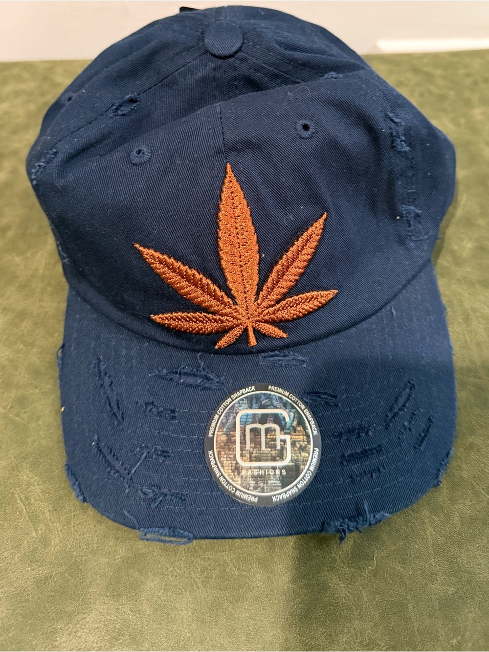 Navy Distressed Baseball Cap with brown embroidered cannabis leaf